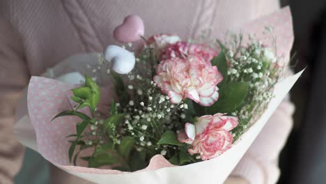 pink carnation bouquet in hands