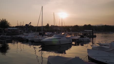 Nostalgic-evening,-scenic-sunset-on-Lake-Garda,-boat-sleeping-in-the-small-port