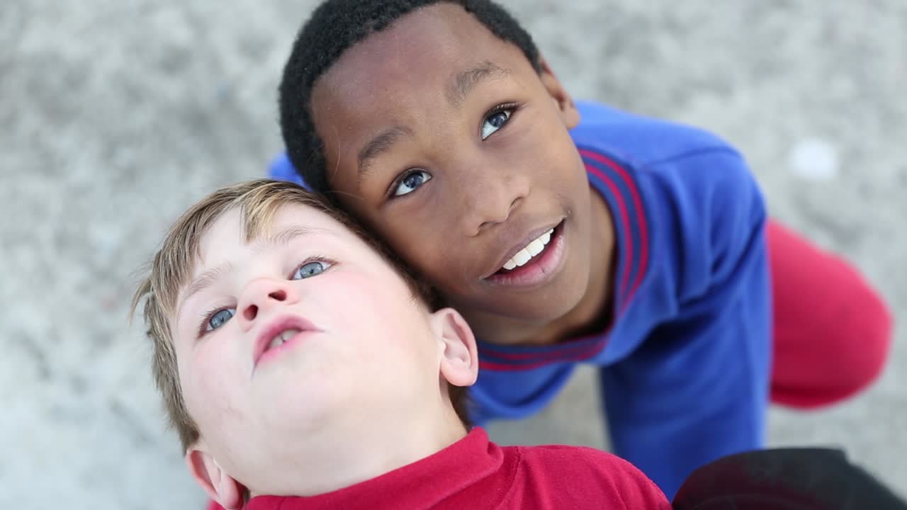 Best friends look up into the sky with childish wonder