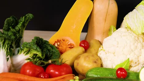 assorted vegetables arranged on a black background