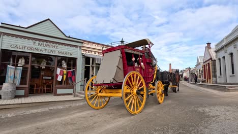 horse-drawn carriage moving through old town street