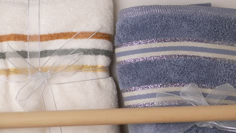 wrapped striped towels on a wooden rod