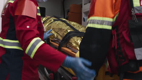 paramedics loading a patient into an ambulance