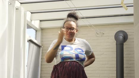 portrait low angle female waving and giving kiss hands towards the camera indoors