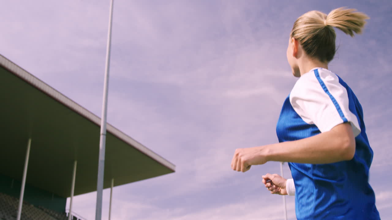 Football player kicking the ball with head