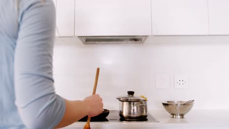 woman cooking food in kitchen