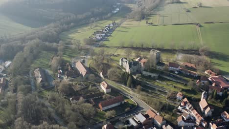 drone aerial view of the fairytale castle adelebsen on a beautiful autmn afternoon in golden sunlight