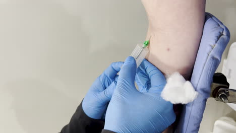 vertical capture of a woman having her blood drawn for testing