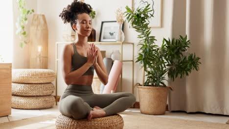 woman practicing yoga and meditation at home