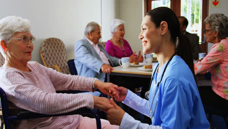 Side-view-of-Caucasian-female-doctor-consoling-sad-disabled-senior-woman-at-nursing-home-4k