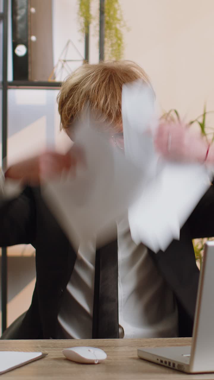 Mad angry businessman analyzing paperwork mistake throws paper bills stress deadline trouble