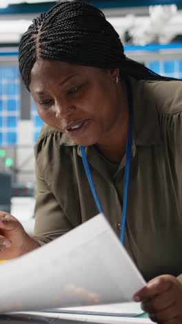 Vertical Video General manager reviewing production line system in a solar facility