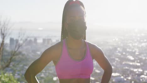 portrait of african american woman wearing face mask standing outdoors