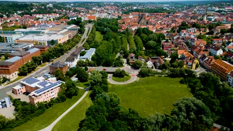 4k aerial drone video of rezatparkplatz west parking lot along the frankische rezat river in ansbach, germany