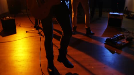 musician playing guitar in studio