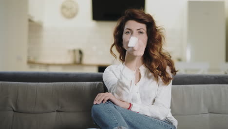 concentrated woman searching tv program in the kitchen