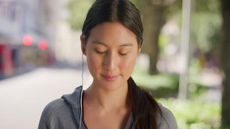 Portrait-of-active-young-woman-listening-to-music
