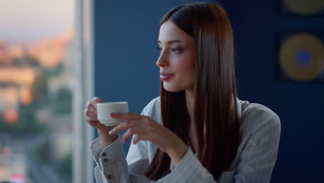 relaxed girl having coffee break in coworking