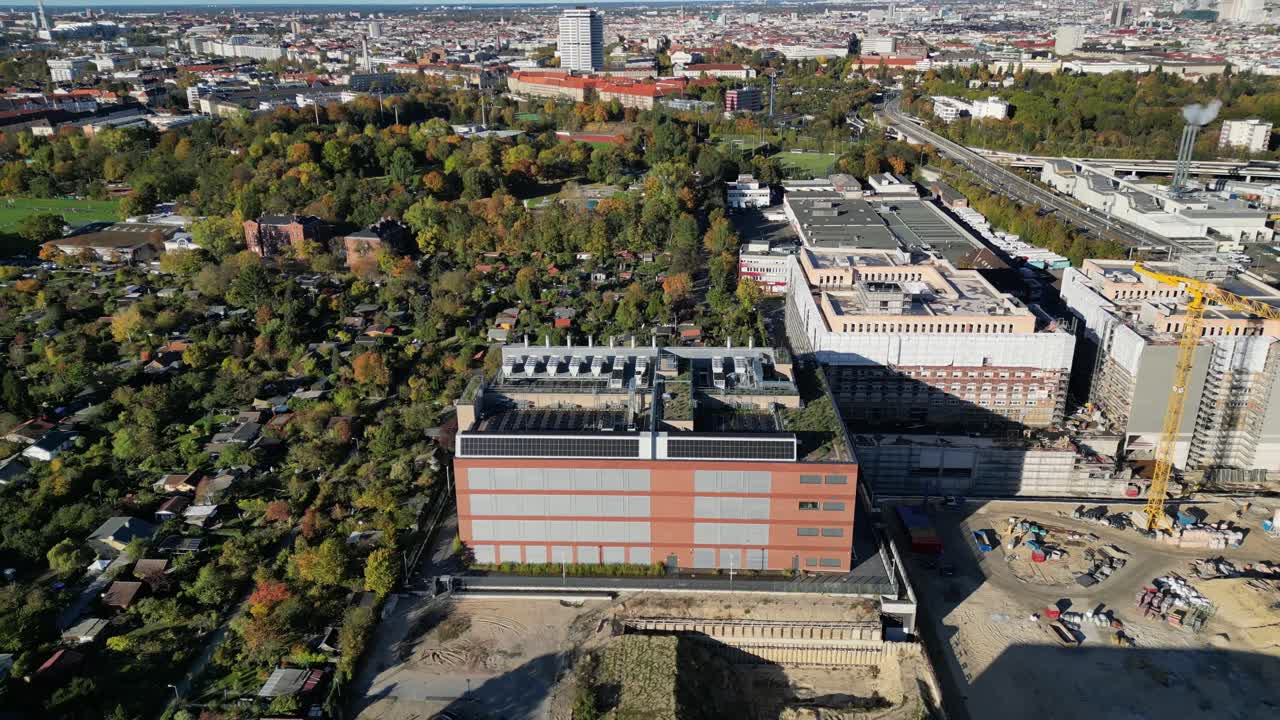 data center, computing center hyperscaler computer servers, cloud services, it services. Building exterior. Dramatic aerial view flight fly reverse drone camera pointing down