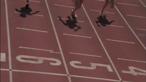 three women run on a running track