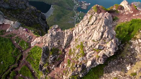 Hiker-woman-standing-with-hands-up-achieving-the-top