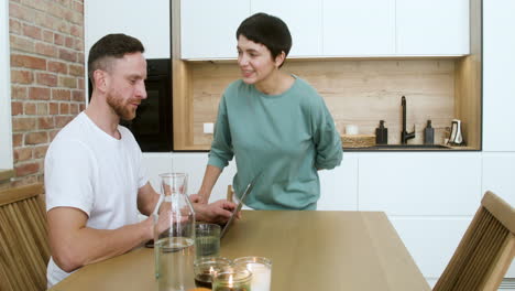 man working on laptop on dining room