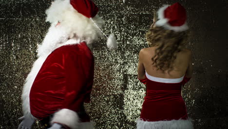 santa claus and woman in xmas costume dance for christmas time disco shoot