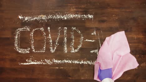 Time-lapse:-Covid-19-letters-sprayed-and-removed-with-pink-wipe