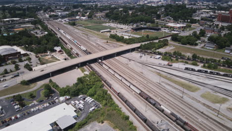 aerial hyperlapse flying over the trainyard and the 3rd street bridge with lookout mountain in the background in chattanooga, tn