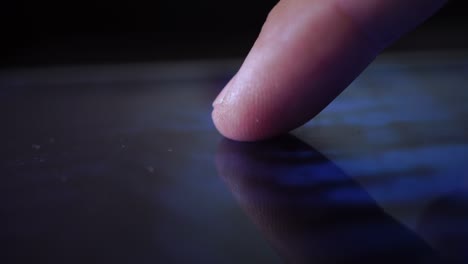 Macro video of a person turning on and off a personal computer with his finger. Technology concept.