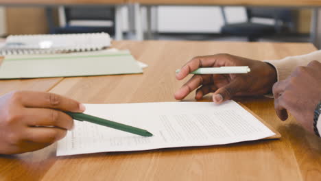 close up view of the hand of a young man signing an employment contract at a job interview