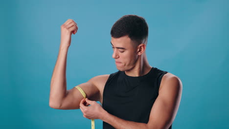 man measuring his muscles