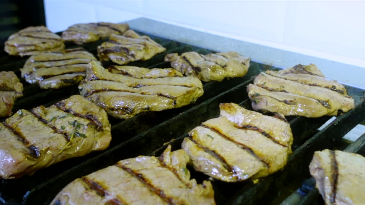 Grilling beef steaks in the kitchen