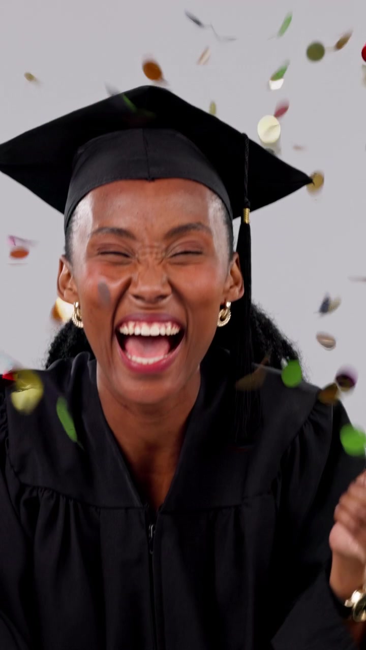 Excited Female Graduate Celebrating Success with Confetti