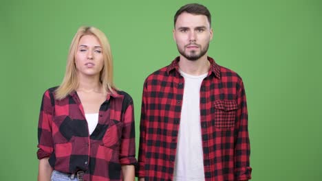young couple looking bored together