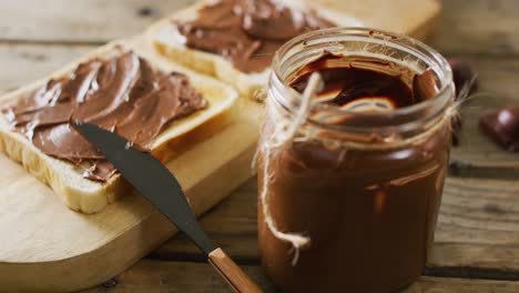Video-of-close-up-of-toasts-with-chocolate-cream-on-wooden-background