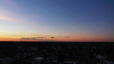 an aerial shot over a suburban neighborhood at sunrise