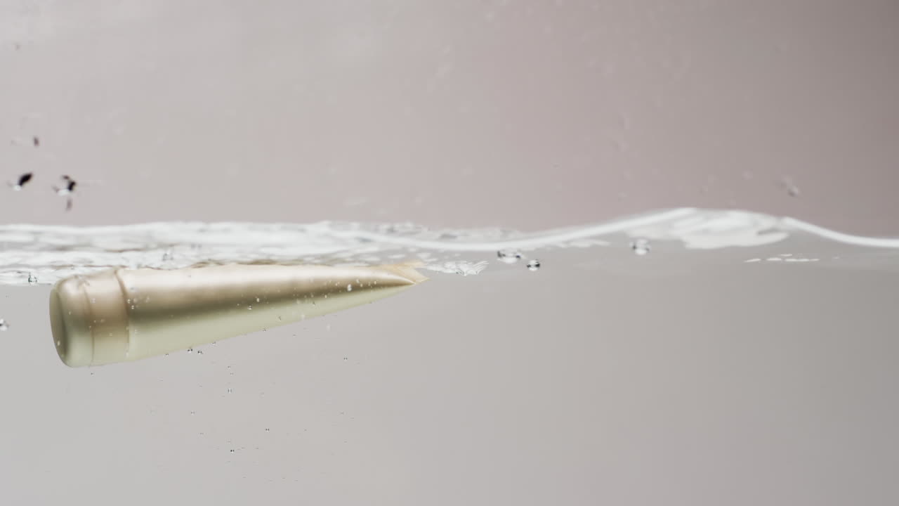 색 배경에 복사 공간과 함께 물에 떨어지는 미용 제품 튜브의 비디오