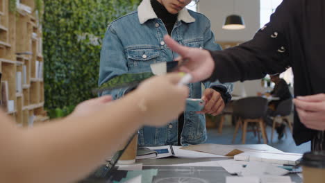 close up young engineers developing bicycle prototype using blueprint schematics students brainstorming future development collaborating sharing creative ideas in trendy office