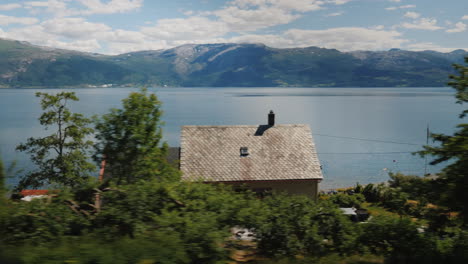 Go-Along-The-Shore-Of-A-Picturesque-Fjord-On-The-Green-Hills-You-Can-See-Traditional-Wooden-Houses-4