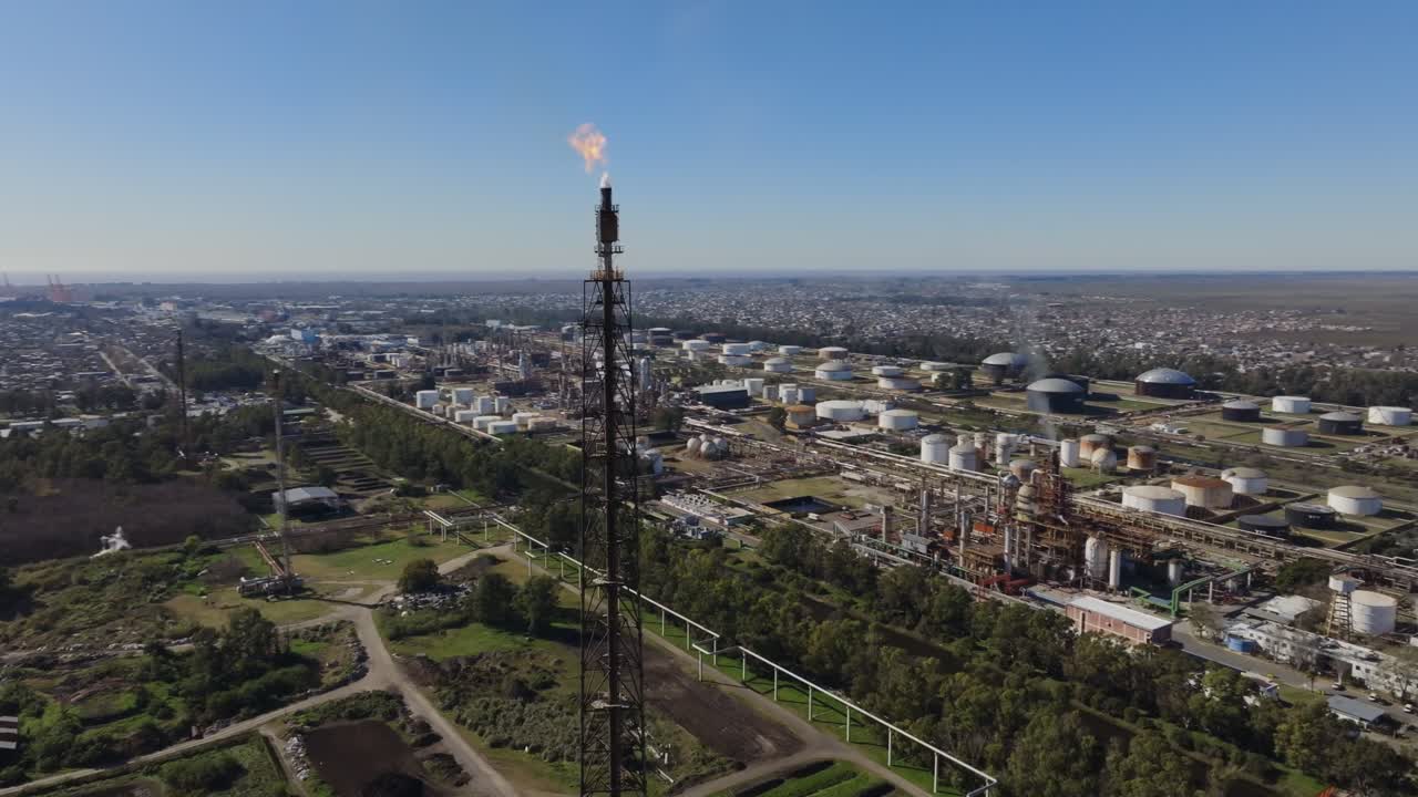Oil refinery and gas plant in Argentina with flare stack flame visible