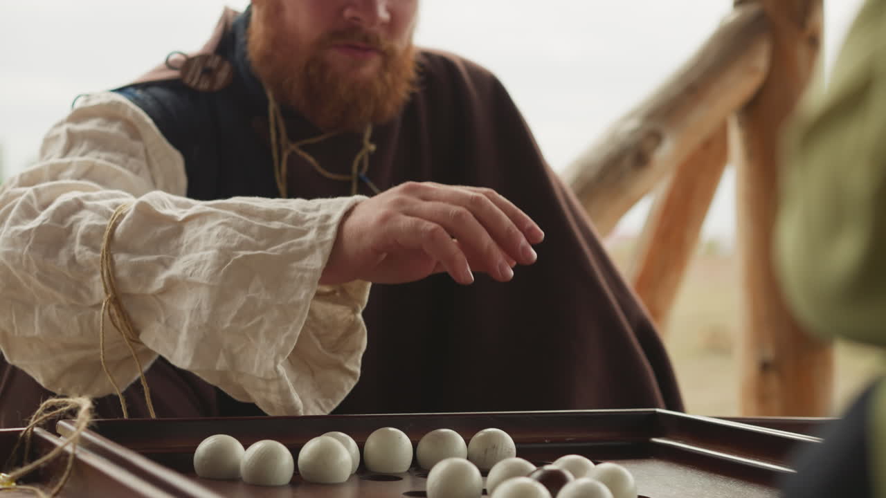 Red-haired bearded man plays board game Suspense Badaboum