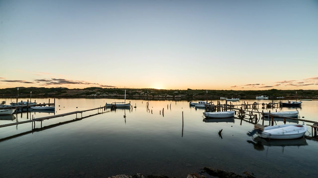 Time lapse sun setting over Port de Sanitija idyllic mountain harbour waterfront landscape
