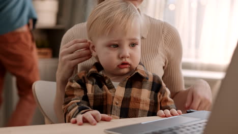 tear-stained toddler in arms of parent