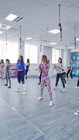 athletic women doing aerobic on a fitness center