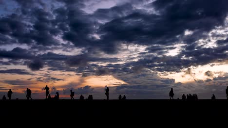 silhouette of people watching sunset in pattaya beach, chon buri, thailand, jun 3, 2022.