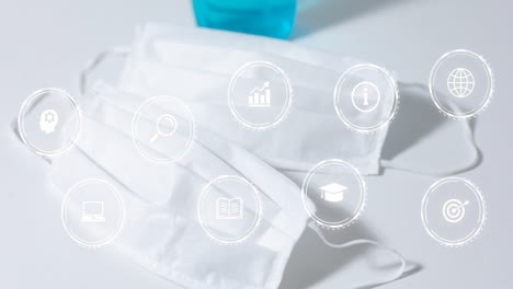 two white masks floating on white surface, featuring nine semi transparent education and tech icons