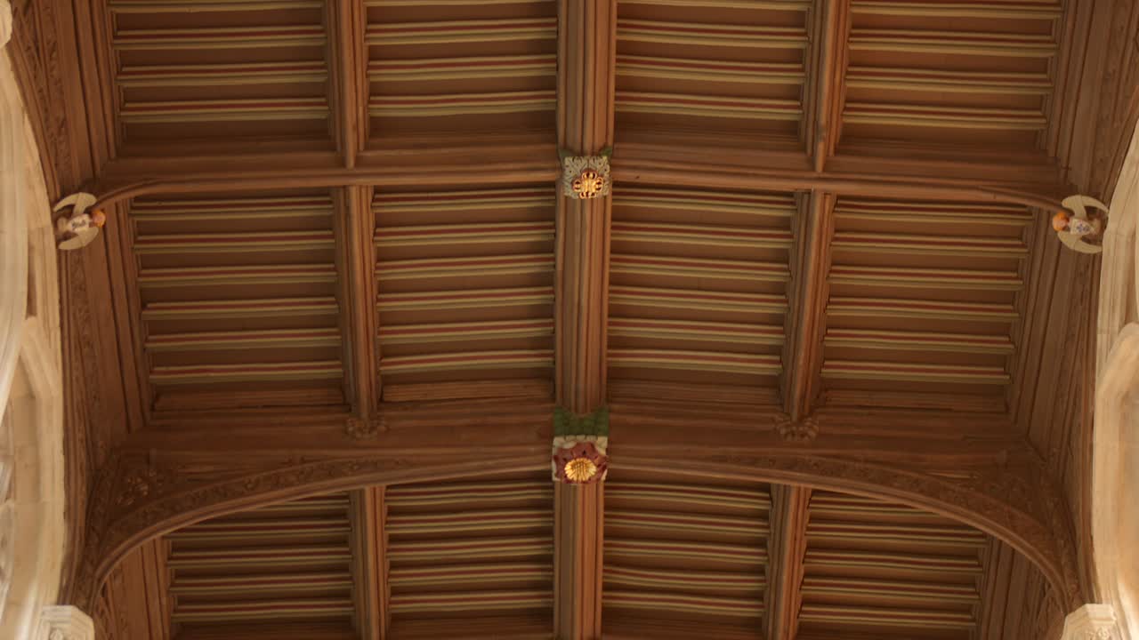 A detailed low-angle view of the historic wooden ceiling in St Mary's Church, Saffron Walden. Medieval timber beams, decorative bosses, and fine English ecclesiastical craftsman