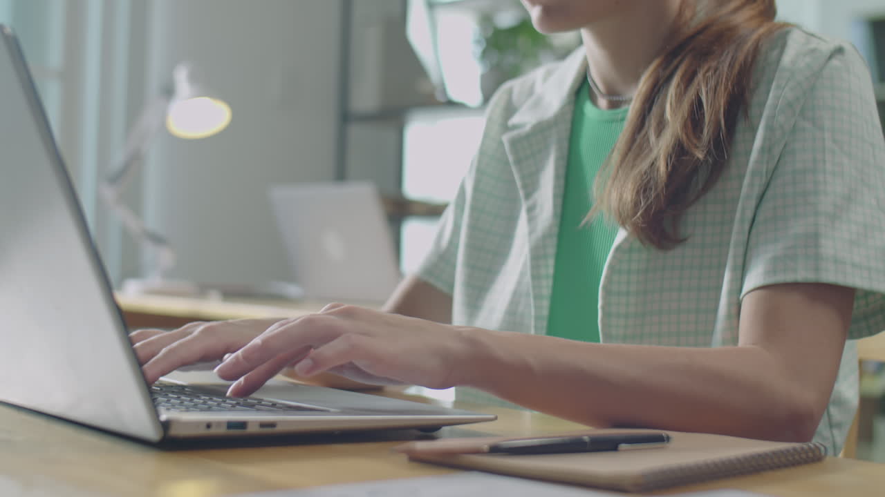 Young Businesswoman Typing on Laptop at Work in Office