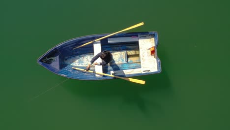 woman on the boat catches a fish on spinning in norway.